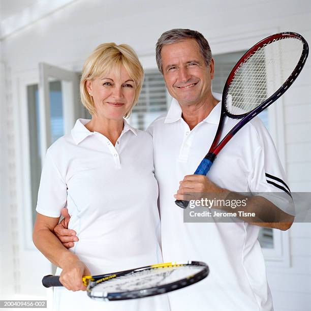 mature couple in tennis outfits smiling, portrait - tennis outfit stock pictures, royalty-free photos & images