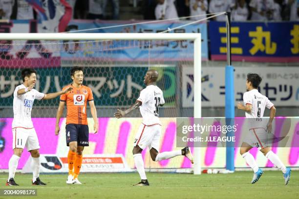 Victor Ibarbo of Sagan Tosu celebrates with teammates Yohei Toyoda and Akito Fukuta after scoring the team's second goal during the J.League J1 match...