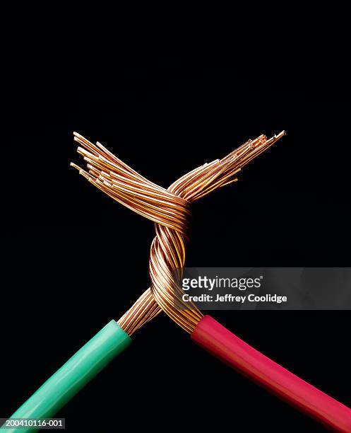 two electrical cables with copper wires twisted together, close-up - cable stock pictures, royalty-free photos & images
