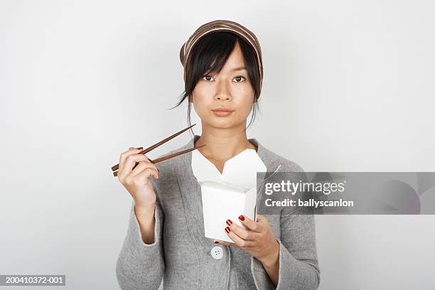 woman holding take out box with chop sticks, portrait - 箸 ストックフォトと画像