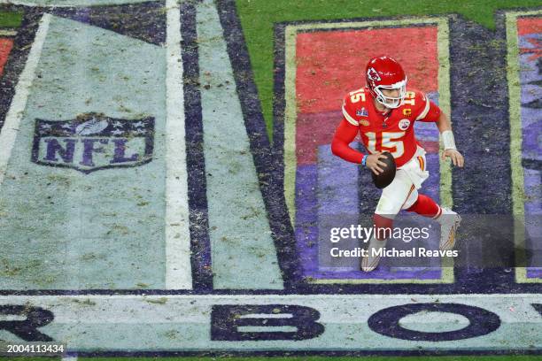 Patrick Mahomes of the Kansas City Chiefs scrambles with the ball in the fourth quarter against the San Francisco 49ers during Super Bowl LVIII at...