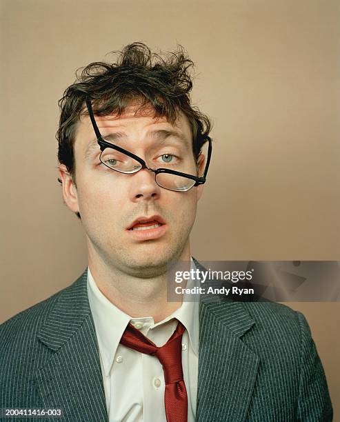 businessman with glasses crooked on face - drunk stockfoto's en -beelden