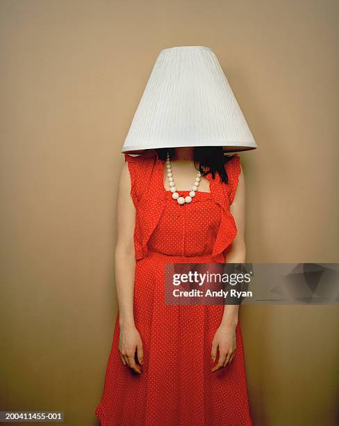 woman wearing red dress with lamp shade on head - lamp shade stock pictures, royalty-free photos & images