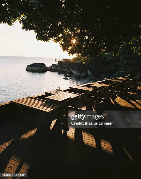 sun loungers on terrace overlooking sea - sun deck stock pictures, royalty-free photos & images
