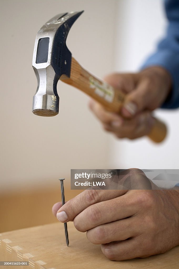 Man hammering nail