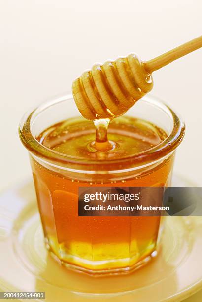 clover honey in jam jar with dipper - honey jar stock pictures, royalty-free photos & images