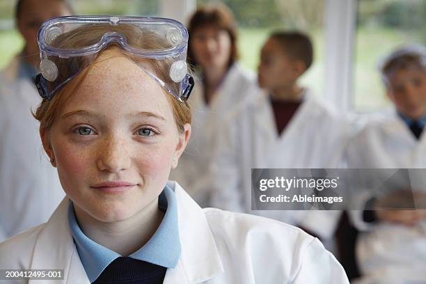 schoolgirl (11-13) in science class, smiling, portrait (focus on girl) - school students science stock pictures, royalty-free photos & images