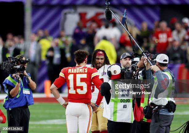 Fred Warner of the San Francisco 49ers and Patrick Mahomes of the Kansas City Chiefs meet at mid-field for the overtime coin toss during Super Bowl...