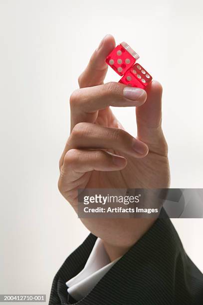 man holding pair of dice, close-up - dice pair stock-fotos und bilder