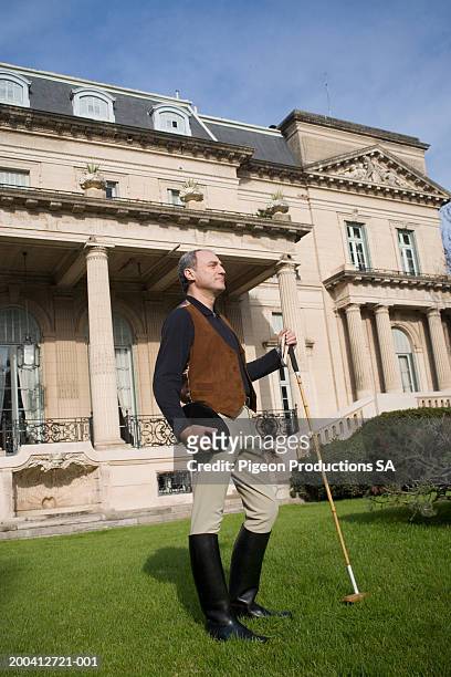 mature man in front of house with polo stick - palacio sans souci stock pictures, royalty-free photos & images