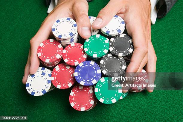 man pushing large stack of poker chips across gaming table, close-up - gambling chip stock pictures, royalty-free photos & images