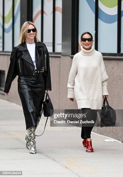 Lisa Aiken seen wearing a black biker jacket, white shirt, black skirt and snakeskin boots and Tracy Taylor seen wearing a cream sweater, black...