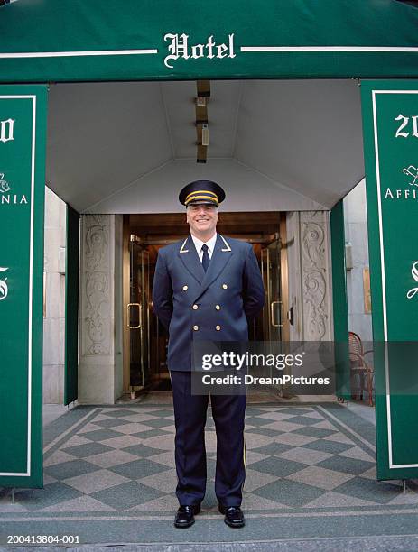 doorman standing outside hotel - ドアマン ストックフォトと画像