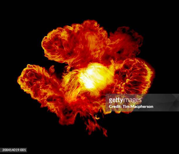 explosive flame against black background (digital composite) - spring stockfoto's en -beelden
