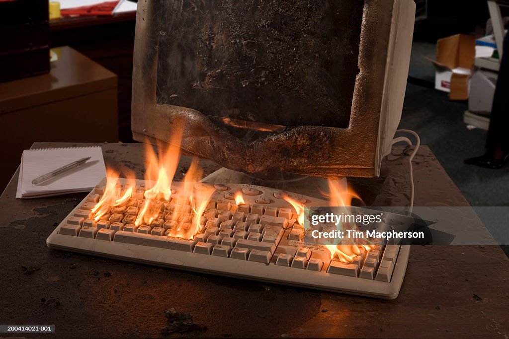 Charred computer terminal and flaming keyboard (Digital Composite)