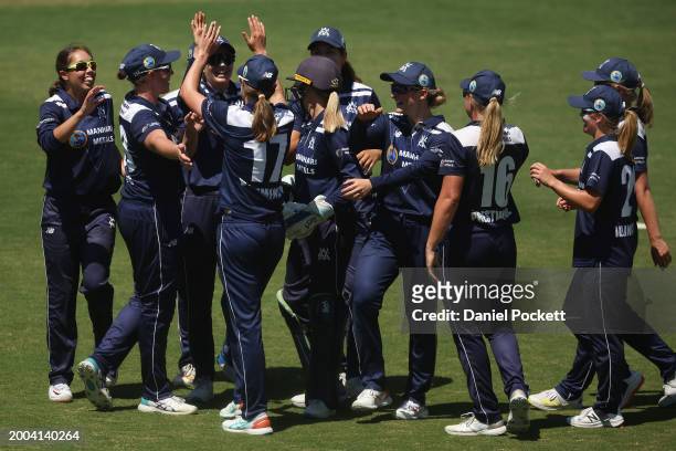 Ella Hayward of Victoria and Tayla Vlaeminck of Victoria celebrate the dismissal of Lizelle Lee of Tasmania during the WNCL match between Victoria...