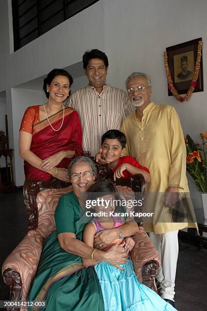 three generational family in living room smiling, portrait - indian mother daughter stock pictures, royalty-free photos & images