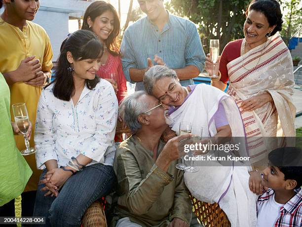 family celebration, grandparents with heads together, smiling - indian family portrait stock pictures, royalty-free photos & images