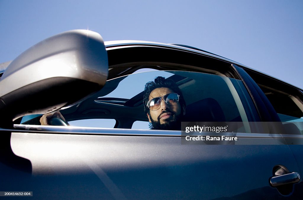 Man in driver's seat looking out window