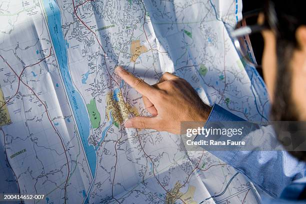 man checking route on road map, rear view - raised finger stock-fotos und bilder