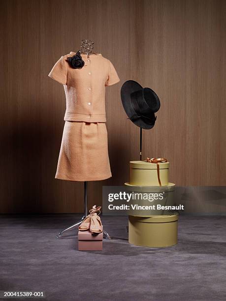 dress on dressmaker's model by hat boxes and shoes - caixa de chapéu imagens e fotografias de stock