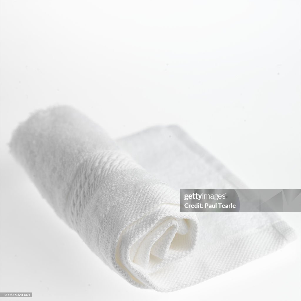 Rolled-up white towel, close up