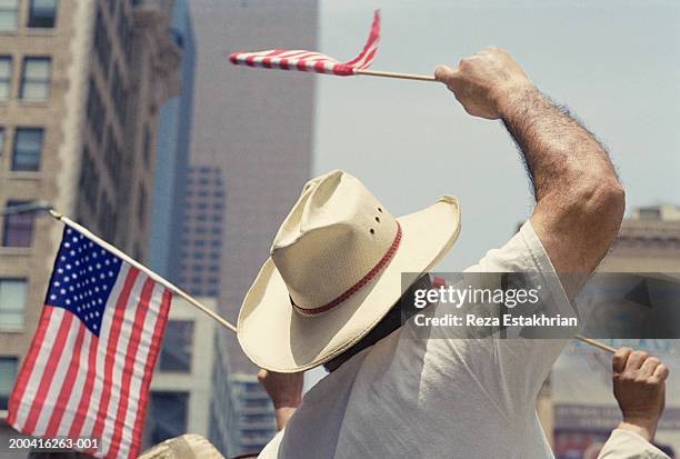 man waving us flag during immigration bill rally in los angeles - emigration och immigration bildbanksfoton och bilder