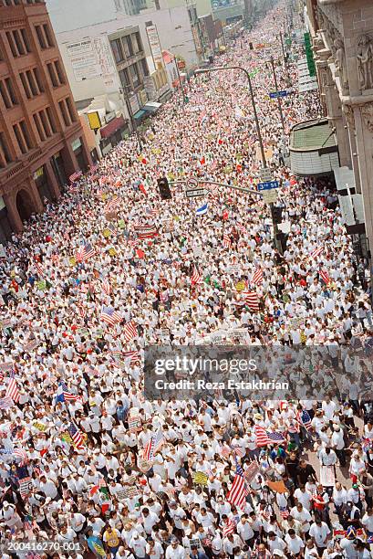 large crowds marching during immigration bill rally in los angeles - marching stock pictures, royalty-free photos & images