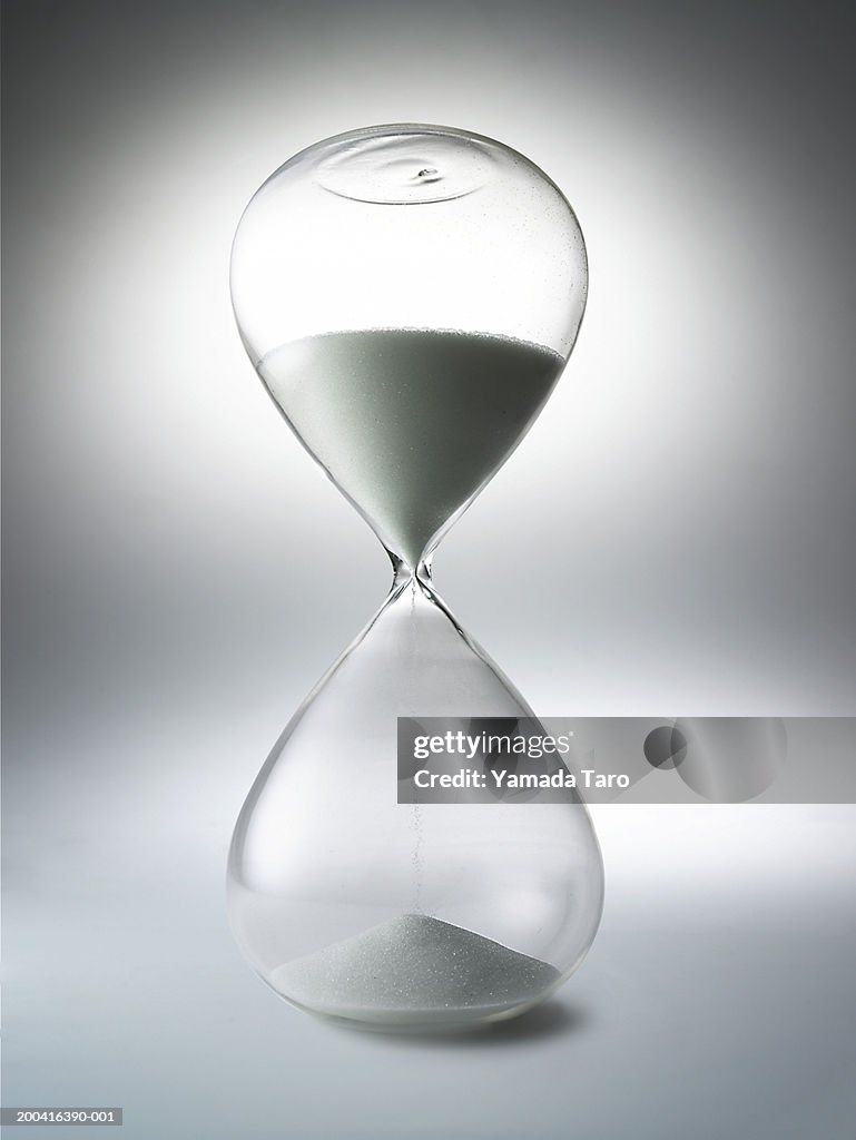 Sand falling through hourglass, close-up