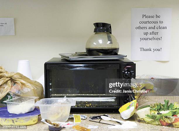 untidy office kitchen area - microwave dish stock pictures, royalty-free photos & images