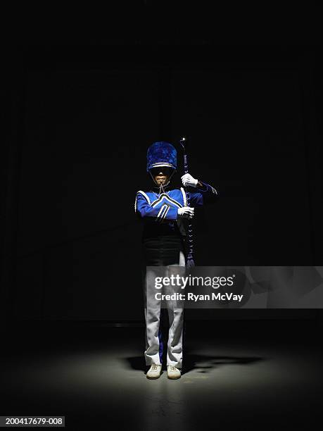 drum majorette blowing whistle, holding baton, portrait - drum majorette stock-fotos und bilder