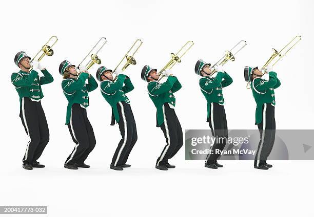 six teenagers (15-17) in marching band uniforms playing trombones - banda de marcha fotografías e imágenes de stock