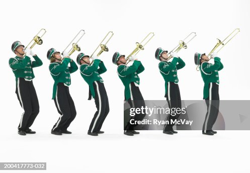 Six teenagers (15-17) in marching band uniforms playing trombones