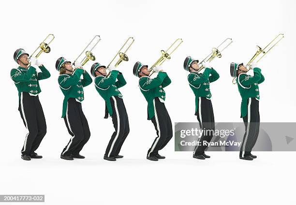 six teenagers (15-17) in marching band uniforms playing trombones - brass instrument stock pictures, royalty-free photos & images