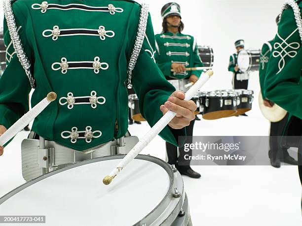 teenagers (16-18) playing drums in marching band (focus on drum) - rehearsing lines stock pictures, royalty-free photos & images