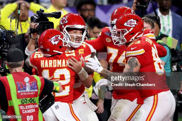 Mecole Hardman Jr. #12 of the Kansas City Chiefs celebrates with Patrick Mahomes and other teammates after scoring the game-winning touchdown in...