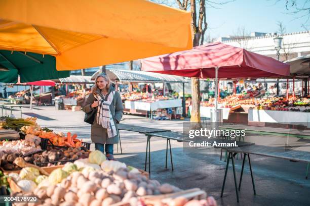 mature caucasian female shopping at urban market - slovenia food stock pictures, royalty-free photos & images