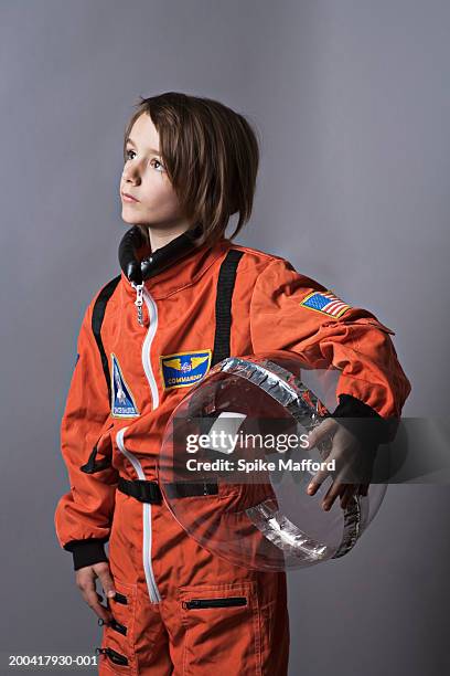 girl (7-9) wearing astronaut costume, looking up - astronaut potrait stock-fotos und bilder