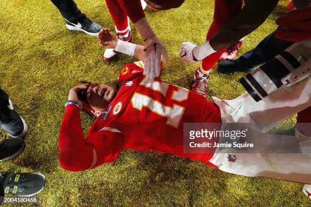 Patrick Mahomes of the Kansas City Chiefs on the ground celebrating defeating the San Francisco 49ers 25-22 during Super Bowl LVIII at Allegiant...