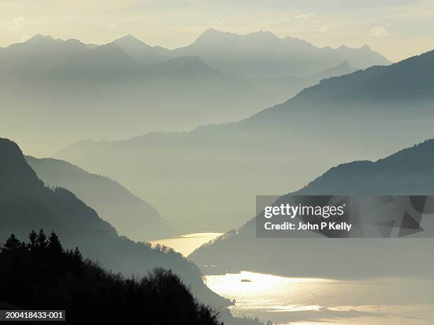 switzerland, graubunden, davos lake and mountains in mist - davos switzerland stock pictures, royalty-free photos & images