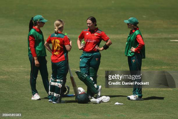 Nicola Carey of Tasmania and Heather Graham of Tasmania cool down at the drinks break during the WNCL match between Victoria and Tasmania at...