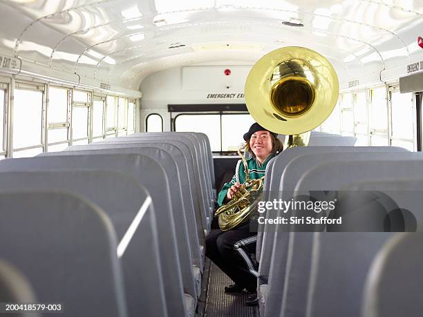 young man in marching band uniform with tuba on school bus, portrait - tuba imagens e fotografias de stock