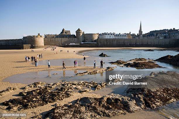 france, brittany, ille-et-vilaine, saint malo, people on beach - saint malo stock pictures, royalty-free photos & images