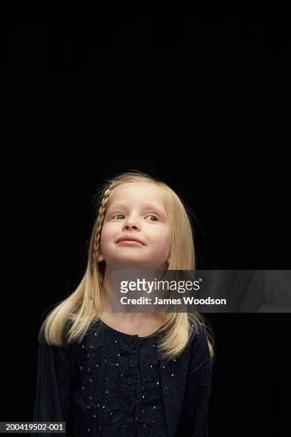 girl (5-7) looking away, close-up - blonde hair black background stock pictures, royalty-free photos & images