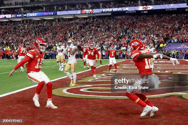 Mecole Hardman Jr. #12 of the Kansas City Chiefs celebrates with Patrick Mahomes after scoring the game-winning touchdown in overtime to defeat the...