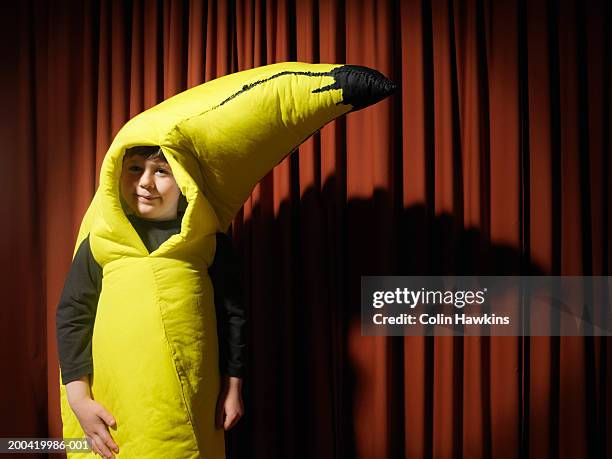 boy (5-7) by stage curtain wearing banana costume, portrait, close-up - 学芸会 ストックフォトと画像