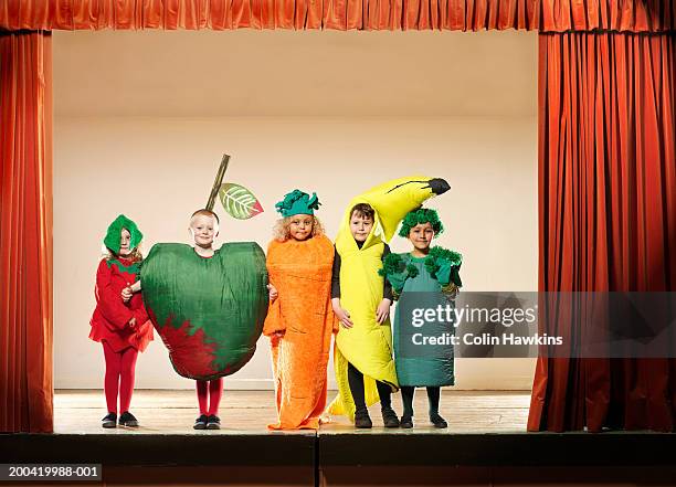 children (4-6) on stage wearing fruit and vegetable costumes, portrait - children theatre imagens e fotografias de stock