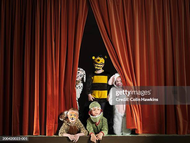 children (5-7) wearing animal costumes on stage, portrait - recita della scuola foto e immagini stock