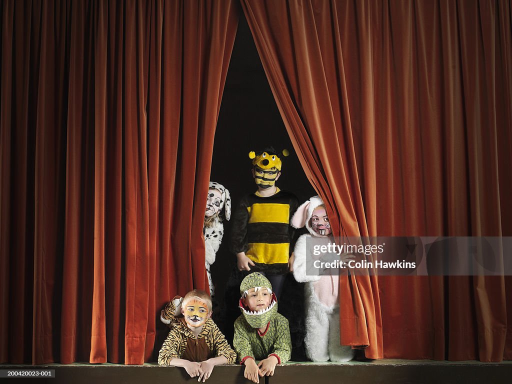 Children (5-7) wearing animal costumes on stage, portrait