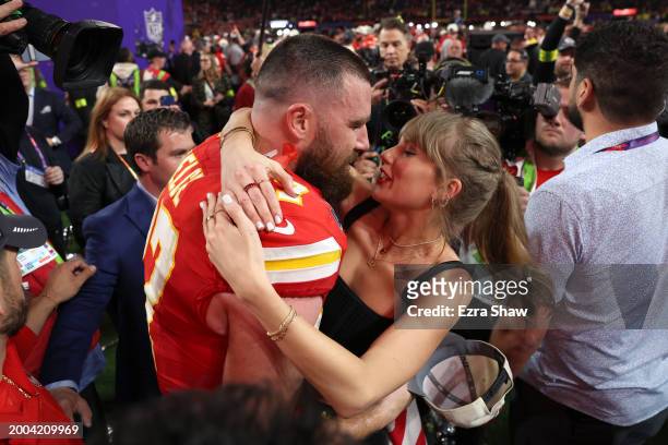 Travis Kelce of the Kansas City Chiefs kisses Taylor Swift after defeating the San Francisco 49ers 25-22 in overtime during Super Bowl LVIII at...